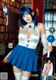 A woman in a blue and white outfit holding a wand.