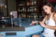 A woman sitting at a bar with a glass of water.