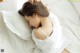 A woman laying on a bed with her head on a pillow.